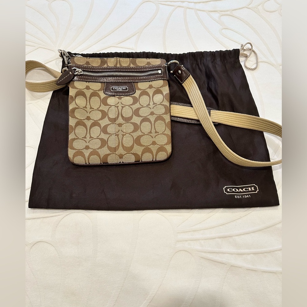 Coach canvas crossbody bag with adjustable strap.